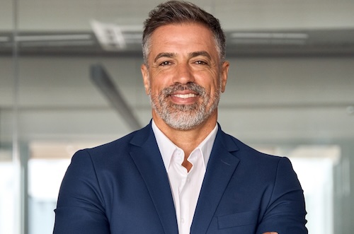 Handsome,Hispanic,Senior,Business,Man,With,Crossed,Arms,Smiling,At